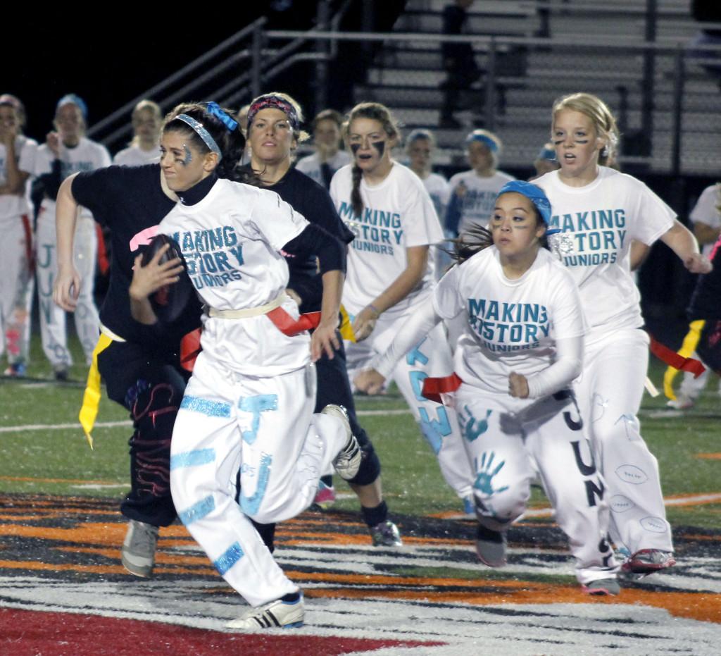 Going for a touchdown. Junior running back Madison Wegener tries to make her way through the senior defenders.