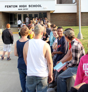 Patiently waiting. Seniors line up early in the morning to receive their schedules and purchase their assigned parking spot. Fenton High rose the price $5 for the 2013-2014 school year to repaint numbers in the student lot.