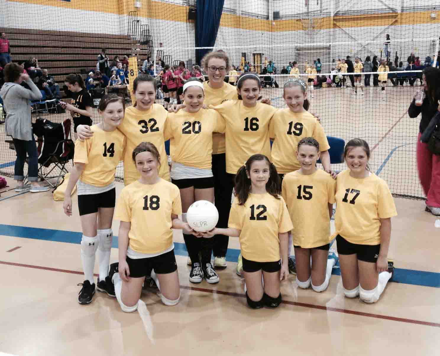  After a weekend tournament, senior Ashley Bearden poses with the volleyball team she coaches. Bearden coaches a group of 12 year old girls through the Southern Lakes Parks & Recreation volleyball program.