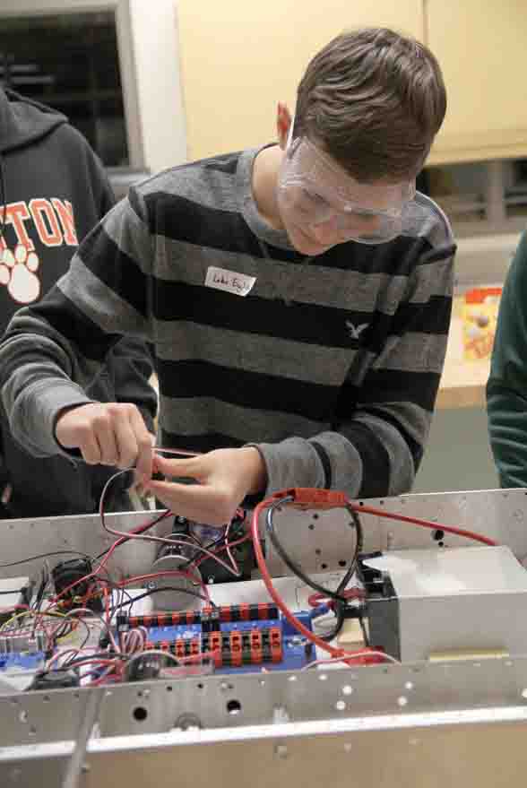 Freshman Luke English puts wires together on the robot in preparation for the team’s upcoming competition that will take place March 6-8 at Kettering University.