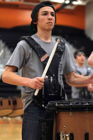 Snare drum around his body, freshman Dom Dimambro performs at the halftime show of a basketball game on Feb 27. “I love performing,” Dimambro said. “There is something about performing and practicing as a group that brings us together. My favorite song to perform was ‘Dream On’ by Aerosmith.”