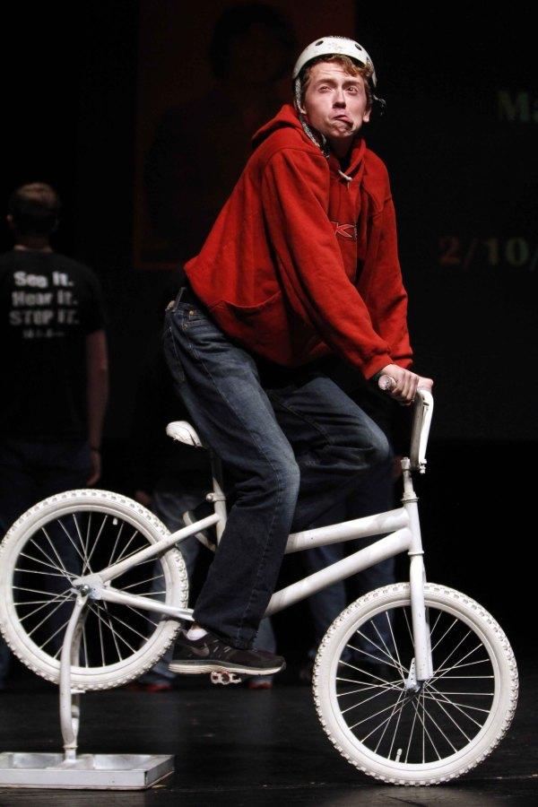 Freshman Arlo Simmerman rides a bike during the monologue of Matt Epling in The Bullycide Project.