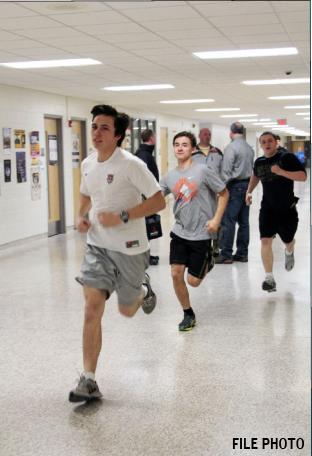 Running through the halls with his teammates, senior Jason Deitrich prepares for the upcoming track season. Indoor track starts two weeks after cross country ends.