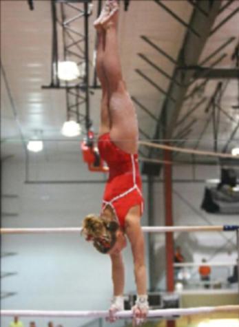 Sophomore Ashley Murphy does a handstand on uneven bars while training for her club team. She has been training for eight years.