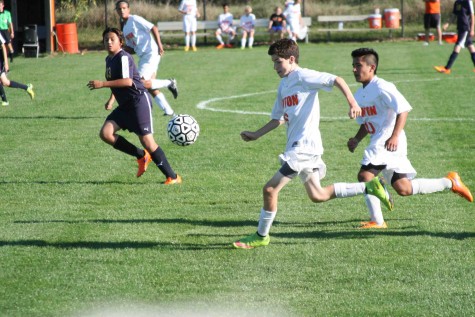 Sophomore Marco Gomez follows sophomore Owen O'Brien to the opponents goal to score for the boys JV soccer team. 