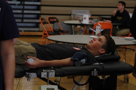 Laying down for the second time, senior Parker Luchenbill waits for his blood to be drawn so it can be donated to the American Red Cross. Its an easy and quick way to give back to people and every person that donates helps save three lives, Luchenbill said. Anyone who is considering donating has nothing to worry about. Its simple and safe.