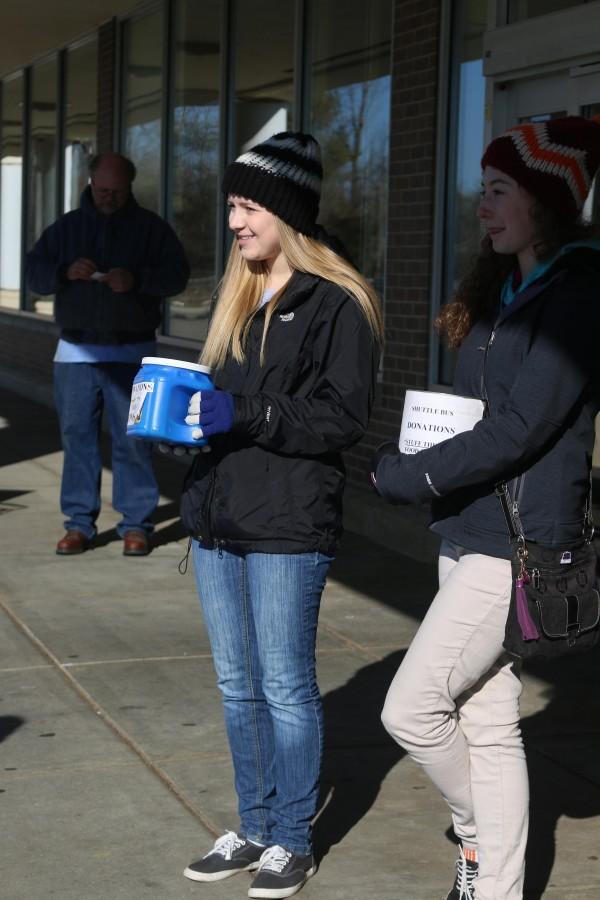 Standing outside of VGs, seniors Erin Bedell and Erin Casey collect nonperishable food items and monetary donations as part of Stuff the Bus. I  volunteered this year because I did it last year and enjoyed seeing the large outcome of items people from our community donated, Bedell said. Its a great cause and I was glad to be able to help in anyway I could. Stuff the Bus collects food and raises money for people in the surrounding communities which is delivered to families in time for Thanksgiving.