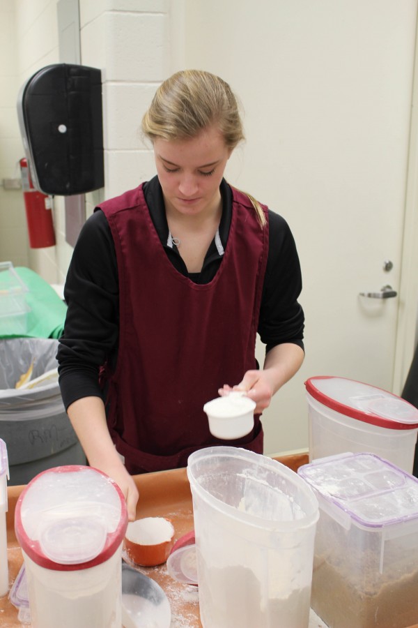 Measuring flour in her foods and nutrition class, sophomore Taylor Shegos works on making pretzels. Were working with yeast in the class. We have to know how to use it, and stuff. There were a few of us absent, so we had three people in our group instead of five, but we still made them. They turned out good, I was expecting them to turn out bad, but they didnt.