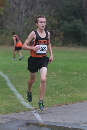 Senior Jake Lee runs through the mud during cross country season. “Indoor track helps us get into good running shape,” Lee said. “We do similar workouts as we do during track to get our mileage up. This also helps for cross country season by keeping us in good form.”