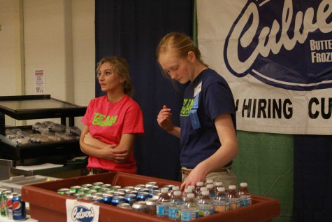 Looking down at the pop and food they are providing, junior Jada Watson helps run the Culvers booth at the community expo over the weekend. I enjoy working at Culvers. Its a fun working experience and I like the positive atmosphere we have.