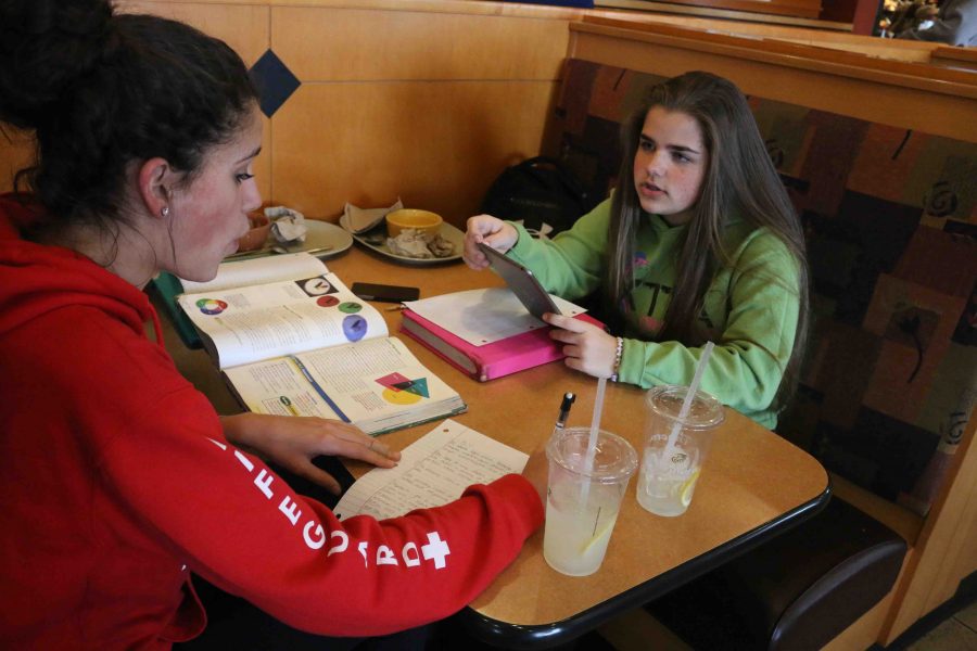 Sitting at the table, freshman Emma Seynko talks to her friend at the Panera Bread fundraiser. I had to go to the fundraiser as a part of my grade, Bunka has us bring her a receipt from that night to prove that we or someone else went a bought something. It was fun, its a good way to study for your exams and tests or just a class in general. I have a good time whenever I go to the fundraiser. My friends and I go to study together and it benefits us in the end.
