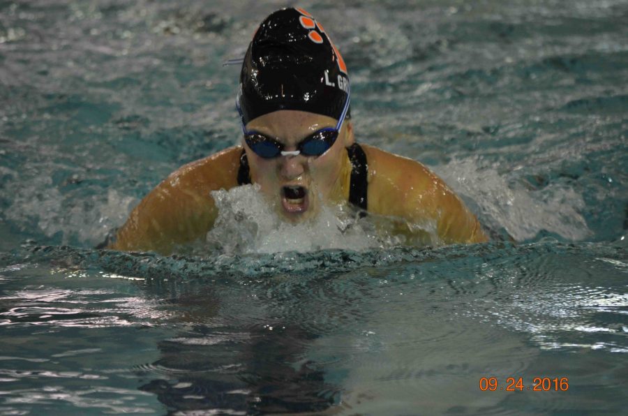 Finishing with a new personal best, senior Lauren Gruber swims in the 100 yard breaststroke. 