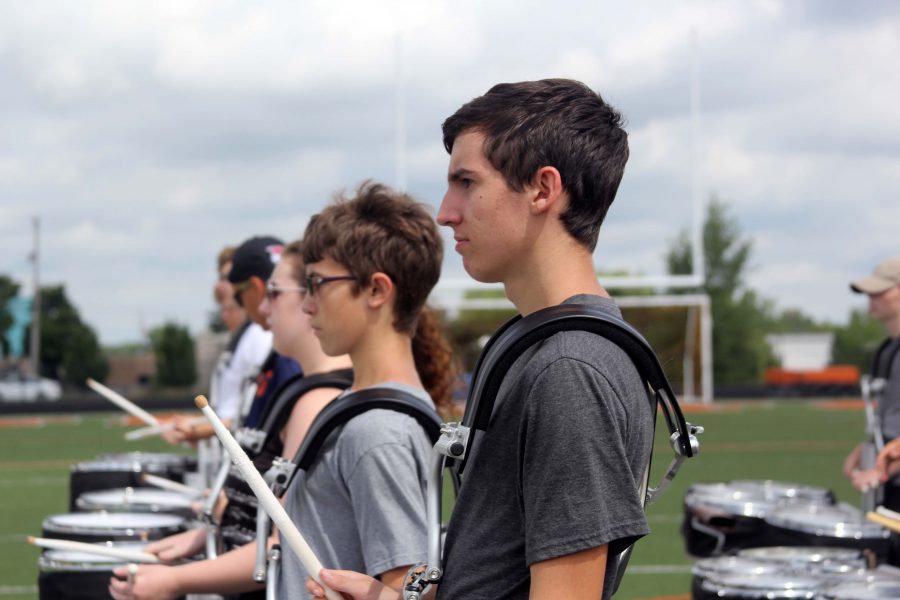 Sophomore Skyler Koleda marches intently while listening to Andrew Perkins directions. Koleda, along with the rest of the band, marched across the football field and played their parts for the song  Holiday by Green Day. 