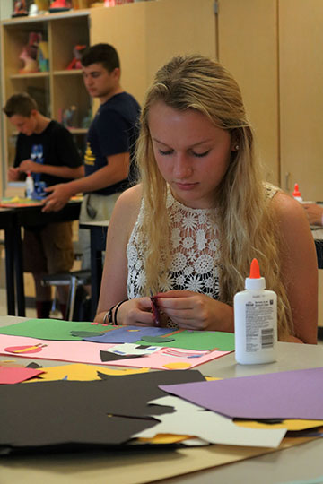 Sophomore Chloe Adams works on her very first art project of her art foundation class. I created a house, I had to pick 18 items of a landscape photo so I picked my house, Adams said.