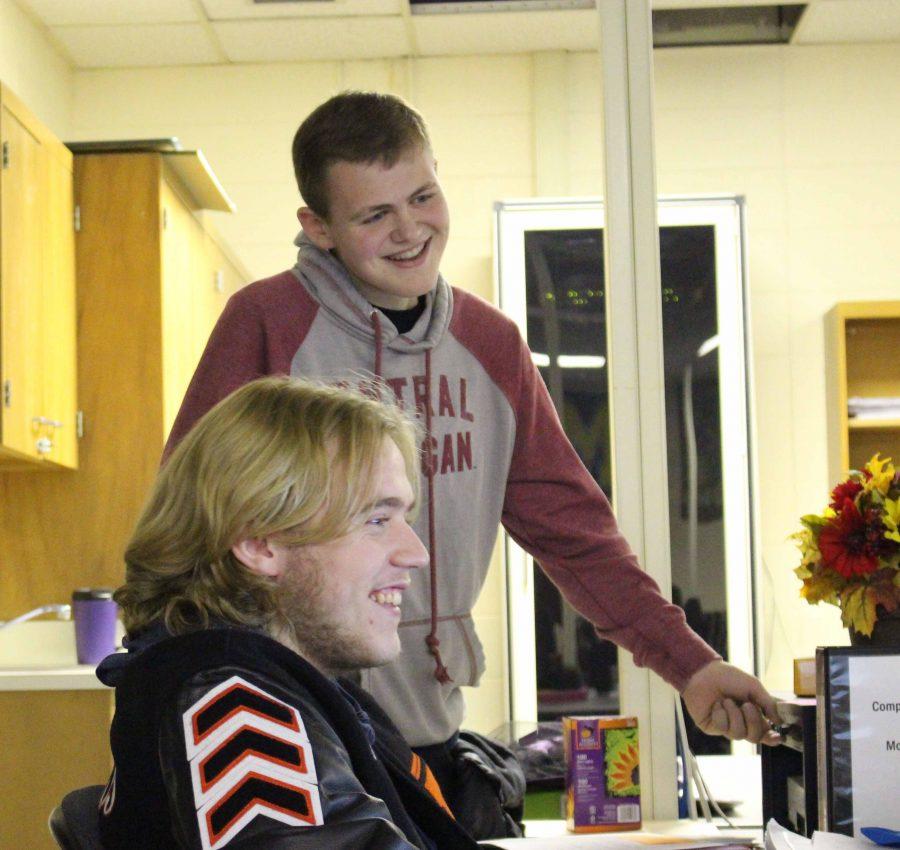 Presenting their self-made apps in computer programming, seniors Nick Hutchings and Taylor Deffandoll laugh together as they play with the volume. After a good laugh, Defandoll finally finds the perfect level of sound.