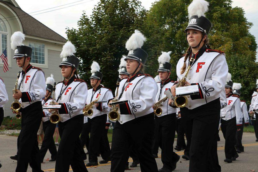 Marching in the homecoming parade Junior Ellery Brickles along with her fellow marching tigers performs before the game. The band later played while the football players took the field.