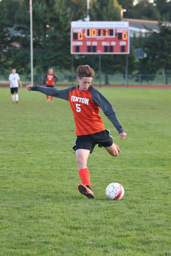 Swinging his left foot back, sophomore Brady Young kicks the ball for a shot on goal. He barley misses, but the tigers still won their game against Linden, 1-0.