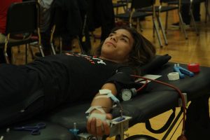 Donating a pint of blood to save 3 lives, senior Emilio Caballero lays down in the gym during the annual NHS blood drive. Not only did Emilio save 3 lives, he also got a free pint of ice cream from Culvers. 