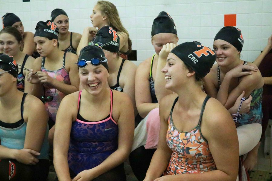 Laughing with the rest of her teammates senior Lauren Gruber learns what event she is swimming later that evening during their meet against Kersley. This meet was different than the others mainly because of how the lineup was chosen, the girls spun a wheel to decide what events that would swim that night.
