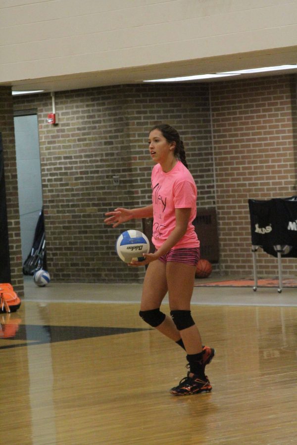 Junior Libby Carpenter prepares to serve the ball at the Volley For A Cure fundraiser on October 12th, 2016.  The volleyball teams played the boys soccer teams and won in terms of money raised and score.  