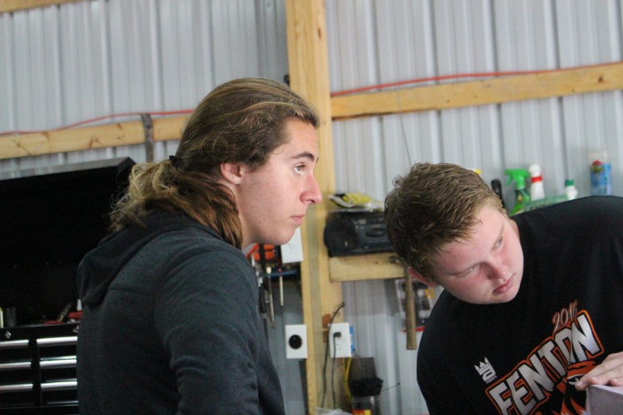 Sophomores Dylan Dockins and Logan Prater help in finishing the UP house for the sophomore float building on Oct. 2.