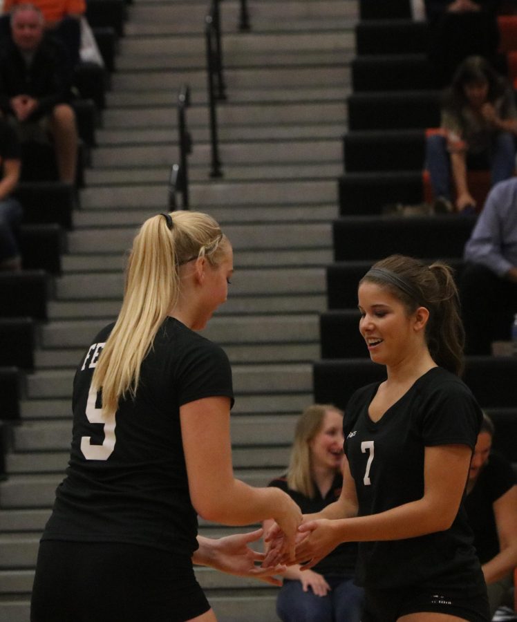 Senior Elise Delecki and sophomore Chloe Idoni do a pre-game handshake before the Holly game on October 4th, 2016.