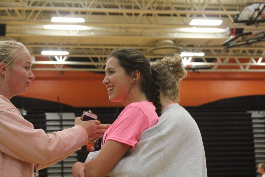 Juniors Libby Carpenter and Molly Gundry laugh and talk about the Volley For A Cure fundraiser afterwards.  The girls beat the boys in volleyball and money raised. 