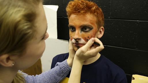Before the first performance of the Little Prince, junior Libby Robinson adds the finishing touches to senior Trent Eatons makeup. Trent played a fox later that night along with other theater students in the children show.