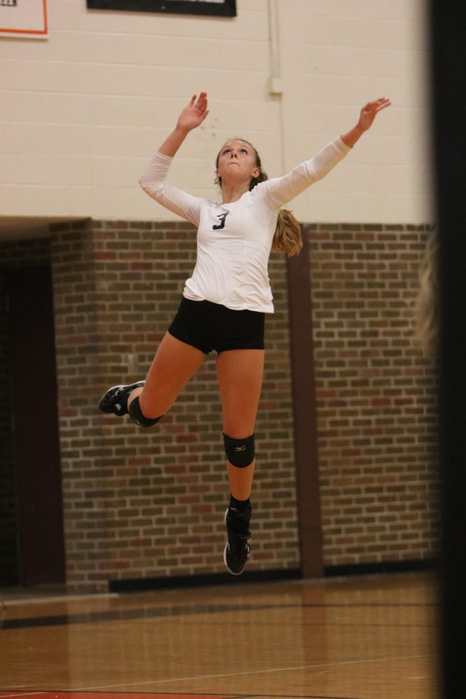  In the midst of a serve, senior Jessica Warford jumps in the air.
