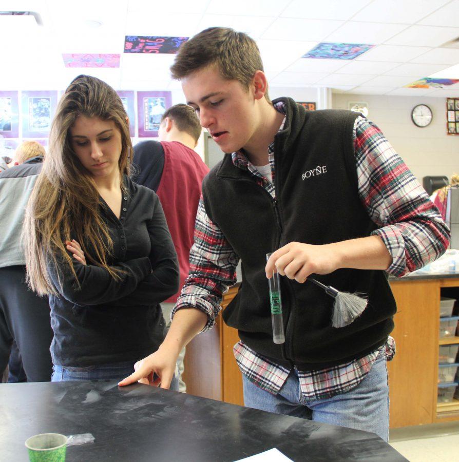 In Forensics class senior Jack Hall and senior Mady Drake participate in a fingerprint lab. The two had to place the fingerprints onto the lab table to learn about forensic science.