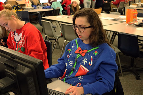 At all staff late night, students dressed in Christmas attire for their holiday picture. Junior, Renae Garcia prepares to call parents that have yet to purchase a yearbook. Garcia practices her speech on how shes going to let the parents know how special the book is.