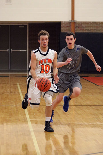 Stealing the ball from Lakeland, sophomore Logan Welch dribbles down the court to shoot for Fenton. 