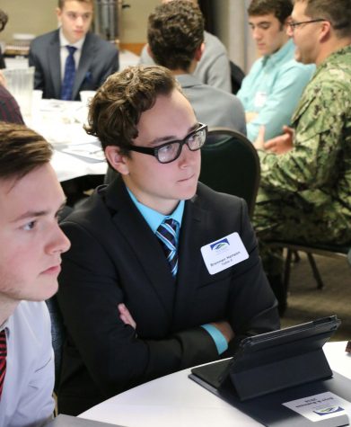 Senior Brennan Hennson listens to the Boys and Business speaker while he is thinking about a possible future in business. 