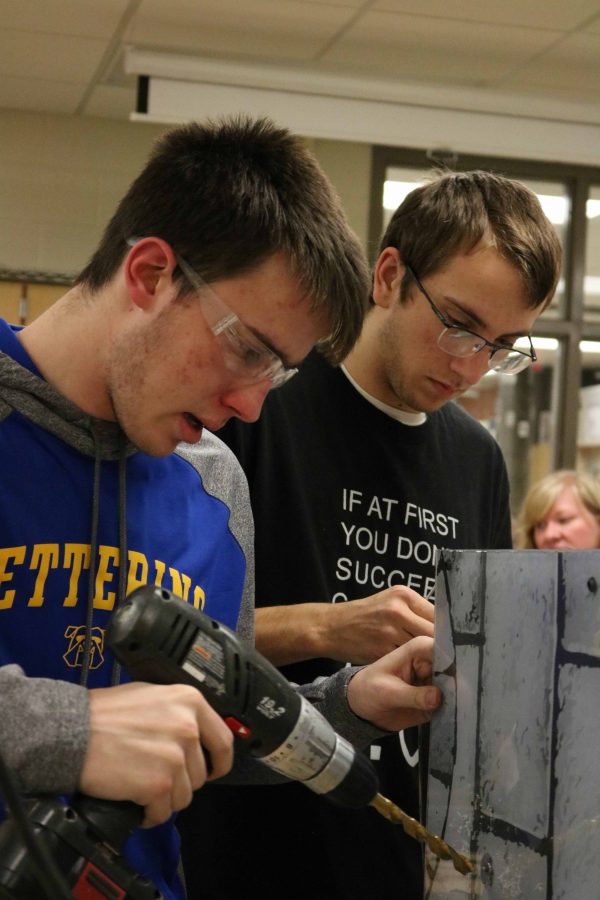 Seniors Kenton Kline and Kenneth Reed work on their award winning robot on Feb. 21.