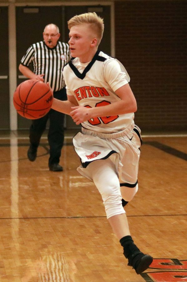 Sophomore Logan Brill runs the basketball down the court during the game against Davison on Jan. 17. 