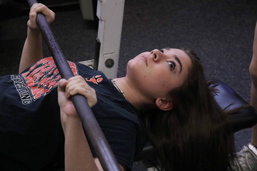 Junior Megan Aneq benches the bar during Fitness and Conditioning on Feb. 2.