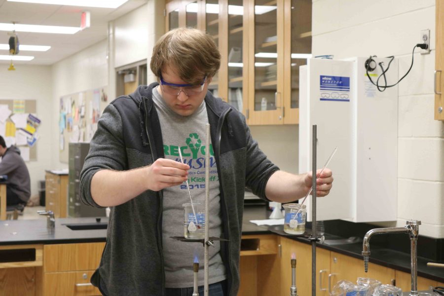 As senior, Andrew Martin checks the temperature in his beakers his focus remains calm and serene. 