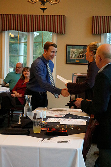 Senior Vincent Barbaretta accepting his varsity letter for boys swim. The senior has been on the team for four years.
