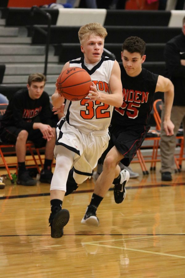 Sophomore Logan Brill dribbles the ball towards the basket at the game against Linden on Feb. 23.