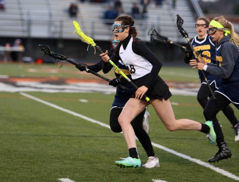 With her eyes on the net, junior Jessica Lynch sprints down the field ready to score during the varsity Lacrosse game against Oxford High School. 