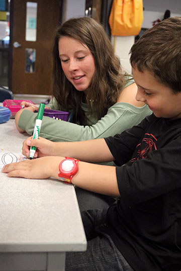 At the AGS middle school senior Jessica Huntley Teaches children how to fill their classmates buckets. The activity she was at she had the kids write something kind on their classmates buckets to spread kindness. 