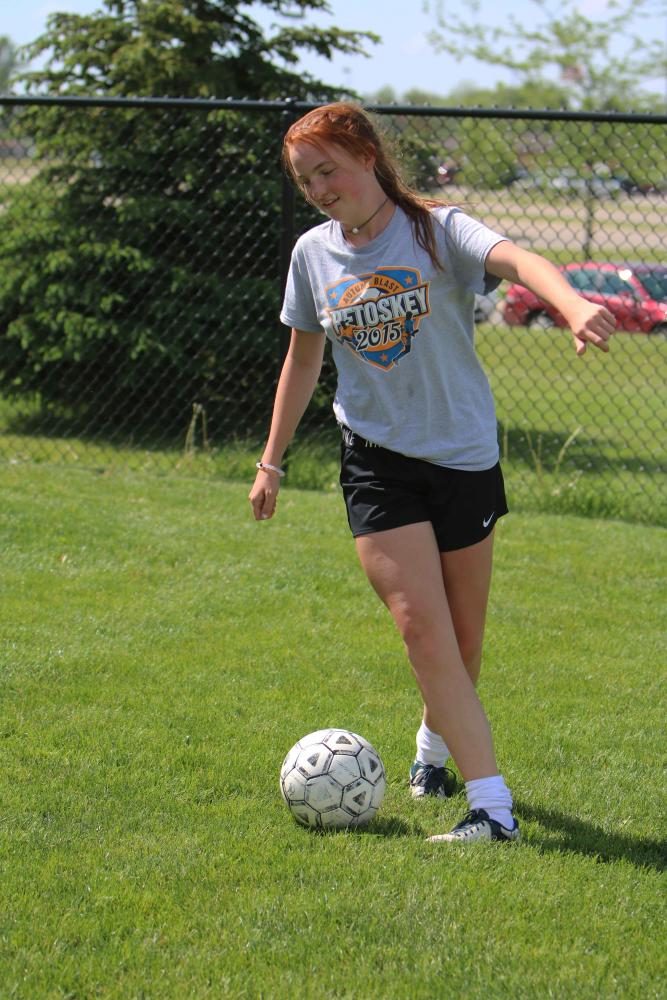 Freshman Julia Adams, passes the soccer ball to one of her teammate. Adams was preparing for their upcoming game against Linden High. 