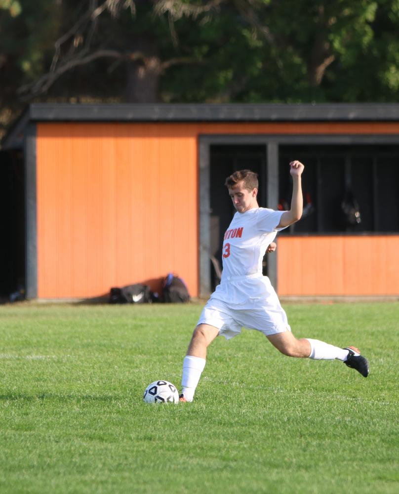 Varsity soccer player, Brayden Moore, prepares to kick the ball into the goal during their before game warm- up. The boys ended the game against Linden with a tie.