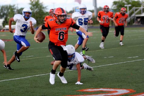 On the run with the football freshman quarterback , Dylan Davidson  gains yards hoping to get a first down for his team. JV Fenton football team won their first game against Brandon.
