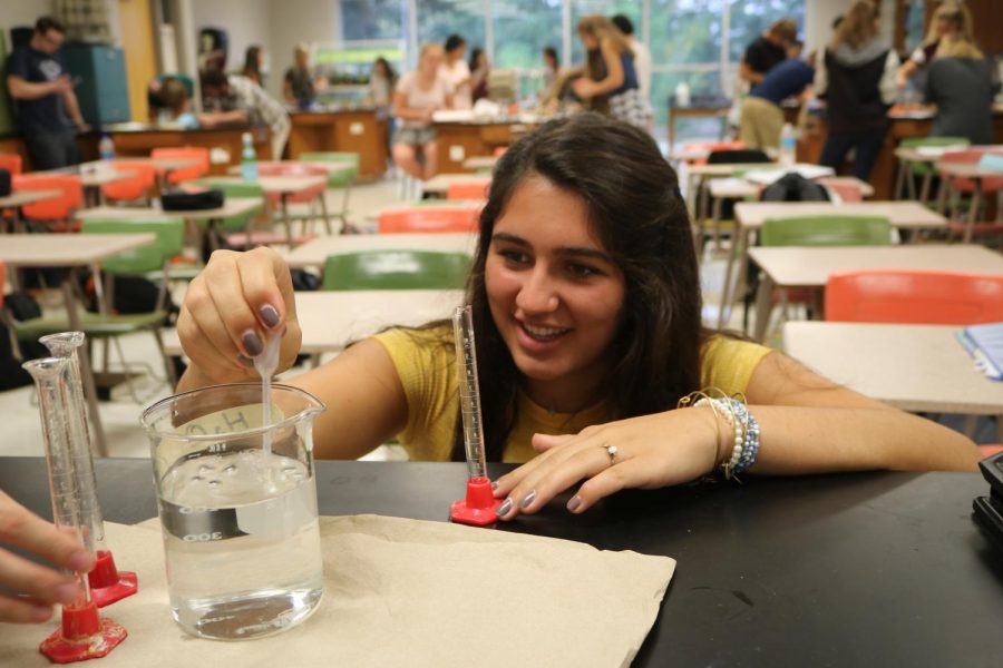Taking part in an enzyme lab, junior Delaney Miesch measures out the amount of hydrogen peroxide needed for the lab. The enzyme lab was the first lab of the year for the anatomy classes.