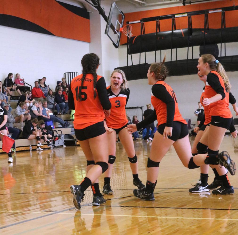 On September 30th at a JV volleyball tournament, sophomore Cheryl Hatch celebrates a point scored with her teammates. The girls went on to win the game and win the full match against Davison. 