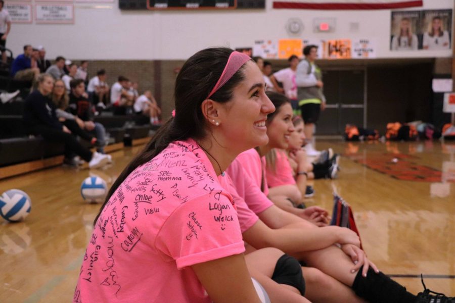 On October 11, Fenton High girls volleyball team play against the boys soccer team to raise money for local families who has cancer. Junior Delaney Miesch, cheered on her teammates with a smile on her face. 
