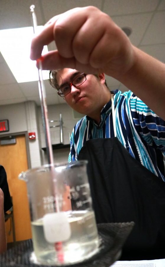 Freshman Jimmy Wright is testing the temperature at a lab with bunsen burners. This lab teaches kids about the melting and boiling of water.