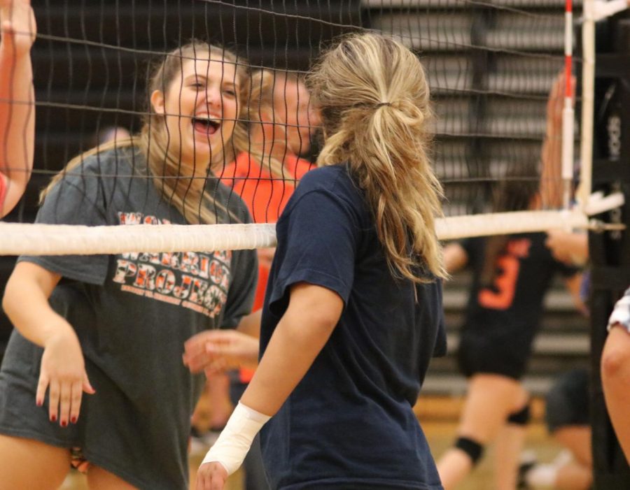Sophomore Morgan Rettenmund celebrates a good play with her fellow teammate. During a practice on October 13th, the girls had fun getting ready to win future games for the JV volleyball team.