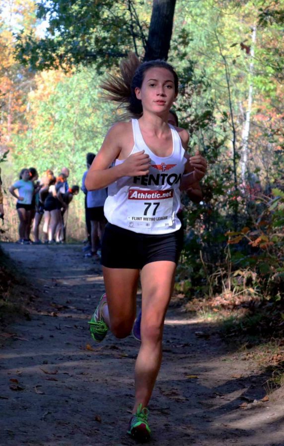 On a Fall Saturday, freshman Kaitlin Bayer runs through the woods to finish her varsity race. The XC teams competed at the Linden High among with several other schools.  